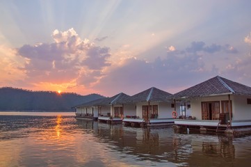 View of over water bungalows in the lake with sunset sky,