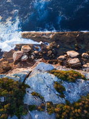 Top down view of cliff and ocean.