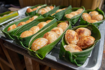 Thai sweetmeat khanomkhrok banana leaf package