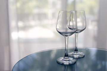 Two wineglasses on the table. Hotel.