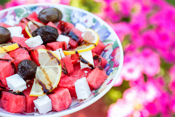 Salad with watermelon, lemon, cheese and olives