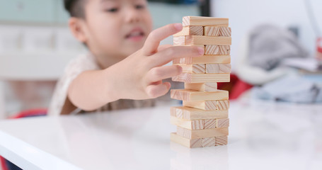 Asian boy play wooden block
