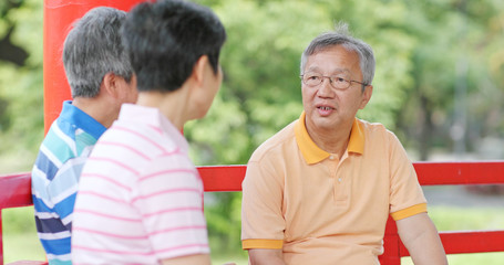 Elderly friends chatting together at park