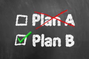 Crossed plan a ticked plan b text on chalkboard or blackboard.