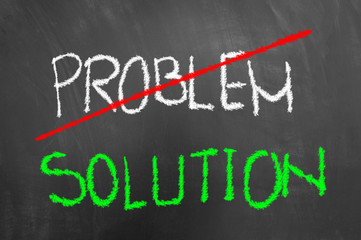 Crossed problem green solution text on chalkboard or blackboard.