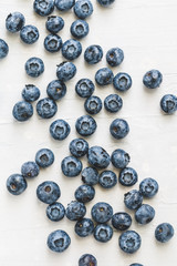 Fresh ripe blueberries over white background. Food background. Top view. The concept of healthy eating and lifestyle.