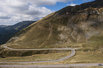 Curved road on hill, in beautiful cloudy day