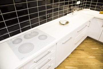 Modern kitchen with white furniture and black decoration