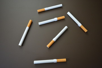Deployed cigarettes on a brown matte background