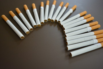Cigarettes are lined on a brown matte background