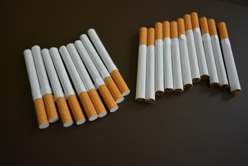 Cigarettes are lined on a brown matte background