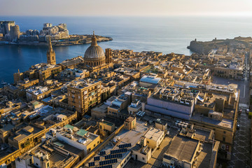 Valletta, Malta - Our Lady of Mount Carmel church and St.Paul's Cathedral from above with Sliema at background at sunrise - obrazy, fototapety, plakaty
