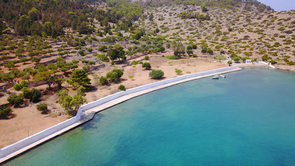 Aerial birds eye view photo taken by drone of famous tropical rocky beach of Agios Georgios with yachts docked, Symi island, Dodecanese, Greece