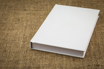 White book on sackcloth textured brown