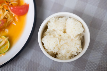 Close up of sticky rice served on white bowl