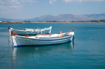 Fototapeta na wymiar small Fishing Boats on shore of Lagoon. Greece