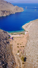 Aerial bird's eye view photo taken by drone of famous tropical rocky beach of Agios Nikolaos with clear turquoise waters, Symi island, Dodecanese, Greece