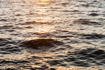 beautiful natural background with wavy sea at sunset