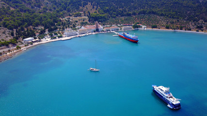 Obraz premium Aerial bird's eye view photo taken by drone from bay and iconic Monastery of Panormitis, Symi island, Dodecanese, Greece