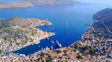 Fototapeta premium Aerial brid's eye photo taken by drone of Yalos, iconic port of Symi island, Dodecanese, Greece