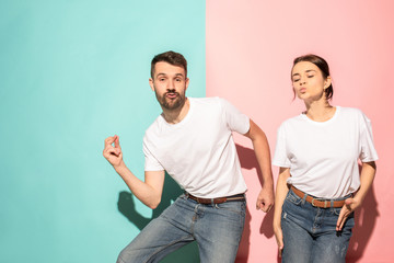 A couple of young man and woman dancing hip-hop at studio.