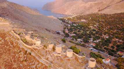 Aerial birds eye view photo taken by drone of Yalos, iconic port of Symi island at sunset with beautiful clouds, Dodecanese, Greece
