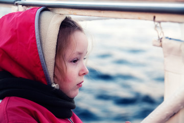 Profile of a girl looking at the water