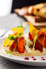 The concept of high European cuisine, molecular cuisine. Dish in an expensive restaurant of vegetables from the garden. expensive table server, on the table instruments and a glass of champagne.