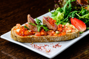 Delicious dish. Fresh bread with juicy meat slices served with c