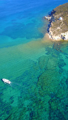 Fototapeta na wymiar Aerial bird's eye view photo taken by drone of famous rocky beach of Livadi Geranou with turquoise clear waters, Patmos island, Greece