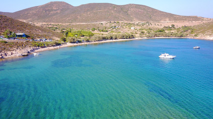 Aerial bird's eye view photo taken by drone of famous rocky beach of Livadi Geranou with turquoise clear waters, Patmos island, Greece