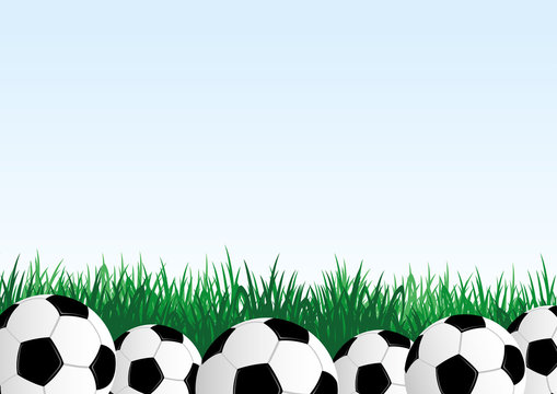 Soccer balls and green grass on a blue background.