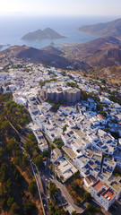 Aerial bird's eye view photo taken by drone of massive fortified stone Monastery of Saint John the Apostle with views to Aegean sea, Patmos island, Greece