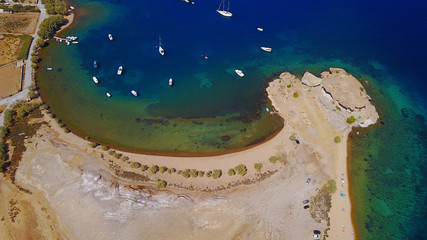 Aerial birds eye view photo taken by drone of famous rock of Kalikatsou in Petra beach, Patmos island, Dodecanese, Greece