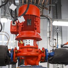 Red pump connected to pipes