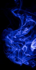 Blue smoke on black background