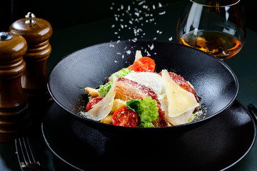 Delicious Ceasar salad with tomatoes, bacon