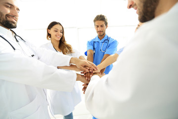 Doctors and nurses in a medical team stacking hands