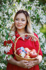Pregnant woman in a blooming apple orchard.