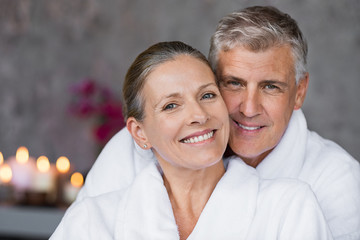Mature couple in bathrobe at spa - obrazy, fototapety, plakaty