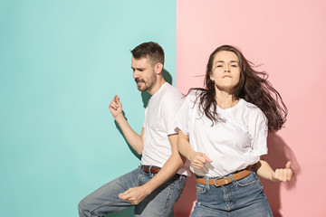 A couple of young man and woman dancing hip-hop at studio.