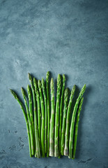 bunch of asparagus on dark concrete background