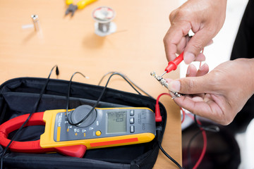 Engineer Repairing and adjustment of the equipment, the audio cable and pliers on the table