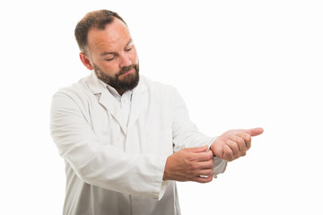 Portrait of male doctor arranging his sleeve