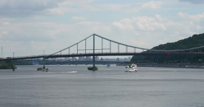 Kiev, A Panorama Of The City With A View Of The Dnieper, A Pleasure Boat Is Sailing, A Powerboat Rides, A Foot Bridge, Excellent Weather, Summer, Cozy In The City, A Reason To Visit For Tourists