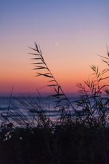 Sunset over Corfu, Greece. Young moon with dramatic sky sunset