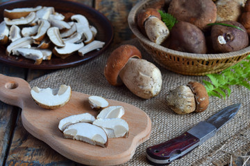 Obraz na płótnie Canvas Porcini. Chopped white mushroom on wooden cutting board. Edible wild mushrooms. Food preparation. Summer or Autumn harvest. Copy space