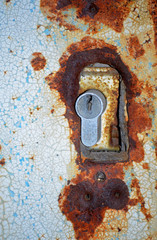 Rusty lock on the metal door