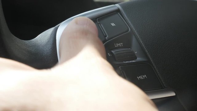 Adjusting driving settings on car steering wheel button set 4K footage