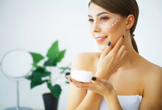 Beauty and Care. Young Woman with Cream for Face in Hands. Morning Skin Care. Young Girl with Well Skinned. High Resolution
